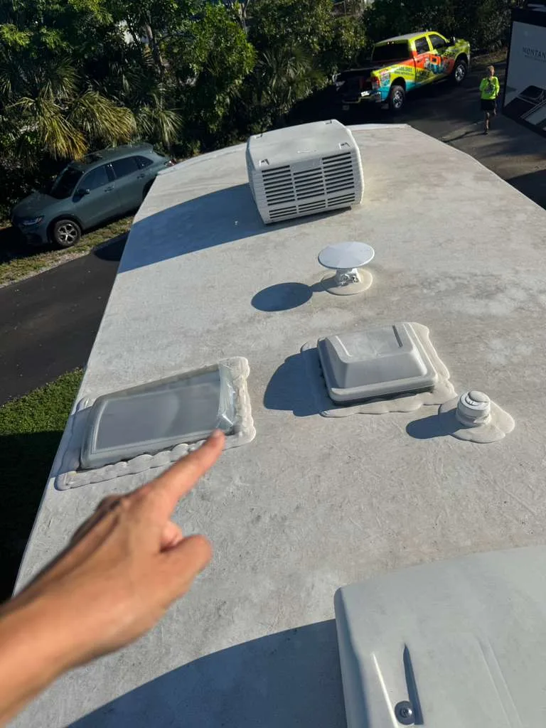 Bolt RV technician repairing a rubber roof leak on an RV in Florida